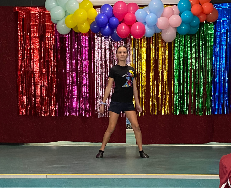 A student dancing on stage.