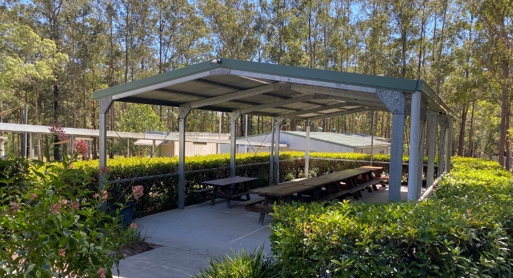 Tables in a covered area in the school grounds.