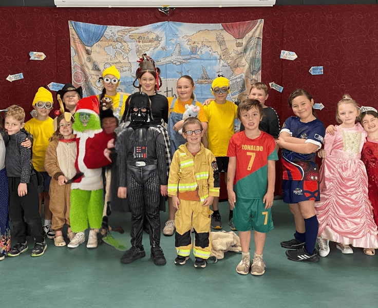 A group of students wearing book themed costumes.